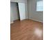 Spacious bedroom with laminate flooring and large closet at 411 Briarwood Rd, Venice, FL 34293