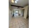 Open dining area with tile floors and access to living room at 411 Briarwood Rd, Venice, FL 34293