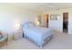 Comfortable bedroom with light blue bedding and wicker chair at 4819 Independence Dr # 4819, Bradenton, FL 34210