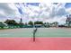 Well-maintained tennis court with red and green surface at 4819 Independence Dr # 4819, Bradenton, FL 34210