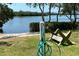 Peaceful waterfront view with a bench and hose at 4819 Independence Dr # 4819, Bradenton, FL 34210