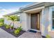 Inviting front entrance with a brick pathway, lush landscaping, and a modern front door with sidelights at 6112 Mesa Gln, Bradenton, FL 34203