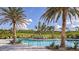 Community pool with lounge chairs and palm trees at 6112 Mesa Gln, Bradenton, FL 34203