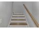 Modern staircase with wooden steps and white risers at 906 E Venice Ave, Venice, FL 34285