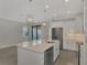 Open concept kitchen with island, stainless steel appliances, and backyard view at 906 E Venice Ave, Venice, FL 34285