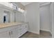 Modern bathroom with double vanity, granite countertop, and tile floor at 906 E Venice Ave, Venice, FL 34285
