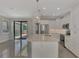 Open kitchen with island, stainless steel appliances, and view to backyard at 906 E Venice Ave, Venice, FL 34285