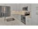 Modern kitchen featuring stainless steel appliances and granite countertops at 906 E Venice Ave, Venice, FL 34285