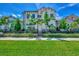 Beautiful two-story house with lush landscaping and gated entrance at 906 E Venice Ave, Venice, FL 34285