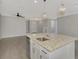 Modern kitchen island with stainless steel dishwasher and sink at 906 E Venice Ave, Venice, FL 34285