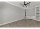 Bright living room with tile flooring, ceiling fan, and built-in shelving at 906 E Venice Ave, Venice, FL 34285