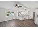Spacious living room with grey vinyl plank flooring and ceiling fans at 403 Pinewood Ave, Nokomis, FL 34275