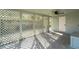Relaxing screened porch with ceiling fan and lattice walls at 403 Pinewood Ave, Nokomis, FL 34275