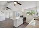 Renovated kitchen boasts a granite island, white cabinets, and stainless steel appliances at 403 Pinewood Ave, Nokomis, FL 34275