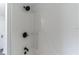 Clean bathroom with white shower walls and black fixtures at 403 Pinewood Ave, Nokomis, FL 34275