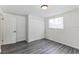 Bright bedroom featuring new flooring and built-in closet at 403 Pinewood Ave, Nokomis, FL 34275