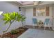 Small patio with seating and tropical plants at 2537 Riverbluff Pkwy # V183, Sarasota, FL 34231