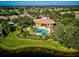 Community pool and clubhouse with lush landscaping at 1480 Mossy Oak Dr, North Port, FL 34287