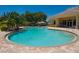 Community pool with a clubhouse and surrounding landscape at 1480 Mossy Oak Dr, North Port, FL 34287