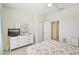 Bedroom with white dresser, TV, and floral bedding at 1480 Mossy Oak Dr, North Port, FL 34287