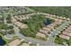 Aerial view of a community with houses and lush green landscaping at 1480 Mossy Oak Dr, North Port, FL 34287