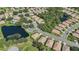 Aerial view of a community with houses, landscaping, and a lake at 1480 Mossy Oak Dr, North Port, FL 34287