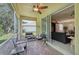 Screened porch with seating and view of living room at 1480 Mossy Oak Dr, North Port, FL 34287