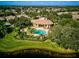 Community pool and clubhouse with lush landscaping at 1480 Mossy Oak Dr, North Port, FL 34287