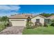 One-story house with a two-car garage and well-manicured lawn at 1480 Mossy Oak Dr, North Port, FL 34287