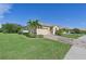 One-story house with a two-car garage and lush green lawn at 1480 Mossy Oak Dr, North Port, FL 34287