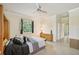 Bedroom with ensuite bathroom access and ceiling fan at 1480 Mossy Oak Dr, North Port, FL 34287