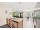 Open concept kitchen with views into living and dining areas at 1480 Mossy Oak Dr, North Port, FL 34287