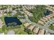 Aerial view of a community with houses, landscaping, and a lake at 1480 Mossy Oak Dr, North Port, FL 34287