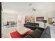 Living room with sectional sofa, coffee table, and open floor plan at 1480 Mossy Oak Dr, North Port, FL 34287