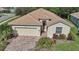 Single-story house with tile roof and brick paver driveway at 1480 Mossy Oak Dr, North Port, FL 34287