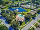 Community pool and clubhouse near a pond at 1480 Mossy Oak Dr, North Port, FL 34287