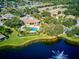 Community pool and clubhouse near a pond at 1480 Mossy Oak Dr, North Port, FL 34287