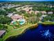 Community pool and clubhouse near a pond at 1480 Mossy Oak Dr, North Port, FL 34287