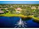 Aerial view of a house with pool, fountain and lake at 1480 Mossy Oak Dr, North Port, FL 34287