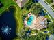 Community pool and clubhouse near a pond at 1480 Mossy Oak Dr, North Port, FL 34287