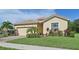 Single-story house with a two-car garage and nicely landscaped yard at 1480 Mossy Oak Dr, North Port, FL 34287