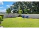 Backyard with grassy lawn, playset, and seating area at 5619 Los Robles Ct, Palmetto, FL 34221