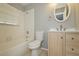 Updated bathroom with light wood vanity, white toilet and bathtub at 13592 Clara Ln, Port Charlotte, FL 33981