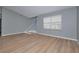 Spacious living room featuring light wood-look vinyl flooring and gray walls at 13592 Clara Ln, Port Charlotte, FL 33981