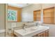 Modern bathroom with double sinks and built-in shelves at 875 Indian Beach Dr, Sarasota, FL 34234