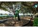 Shaded playground with slide and swings near the water at 875 Indian Beach Dr, Sarasota, FL 34234