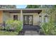 Inviting front porch with double doors and landscaping at 875 Indian Beach Dr, Sarasota, FL 34234