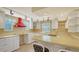 Bright kitchen featuring white cabinetry and a red range hood at 875 Indian Beach Dr, Sarasota, FL 34234