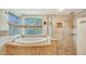 Spa-like bathroom with a large soaking tub and walk-in shower at 875 Indian Beach Dr, Sarasota, FL 34234