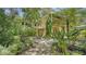 House exterior showcasing lush landscaping and stone path at 875 Indian Beach Dr, Sarasota, FL 34234
